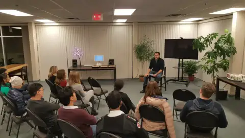 Audience seated in rows listening to a guest speaker