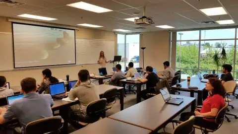 Instructor addressing students in a computer lab setting