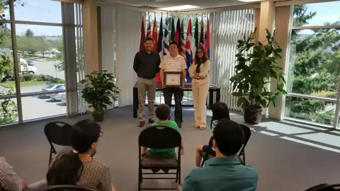Graduate receiving an award certificate during a ceremony